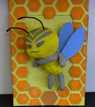 This is a collection of photos of students designing and making their relief sculptures out of newspaper and paper mache
