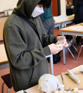 This is a collection of photos of students designing and making their relief sculptures out of newspaper and paper mache