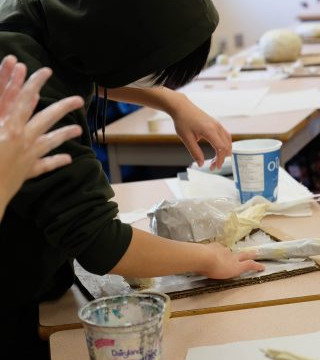 This is a collection of photos of students designing and making their relief sculptures out of newspaper and paper mache