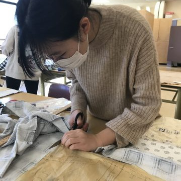 Students in the Textiles 9-12 class working on their pattern layouts for coats, pajama pants, flared pants and culottes.