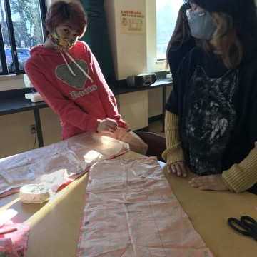 Students in the Textiles 9-12 class working on their pattern layouts for coats, pajama pants, flared pants and culottes.