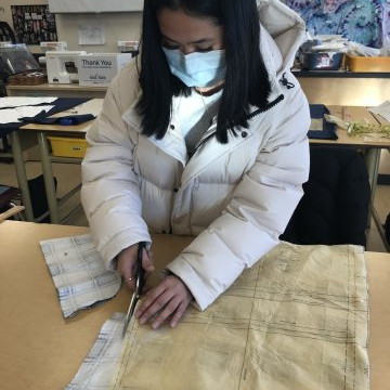 Students in the Textiles 9-12 class working on their pattern layouts for coats, pajama pants, flared pants and culottes.