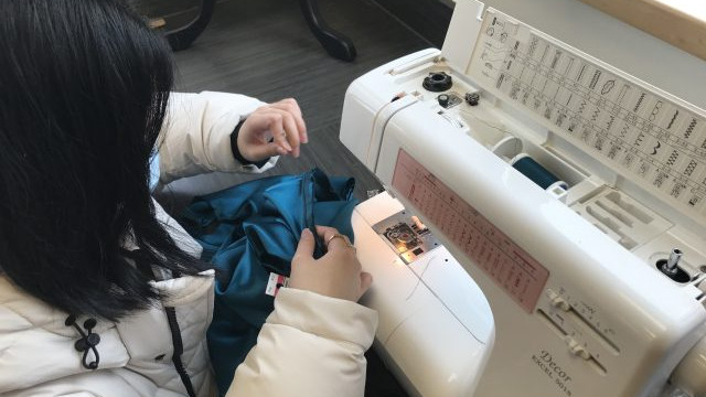 Students in the Textiles 9-12 class working on their pattern layouts for coats, pajama pants, flared pants and culottes.