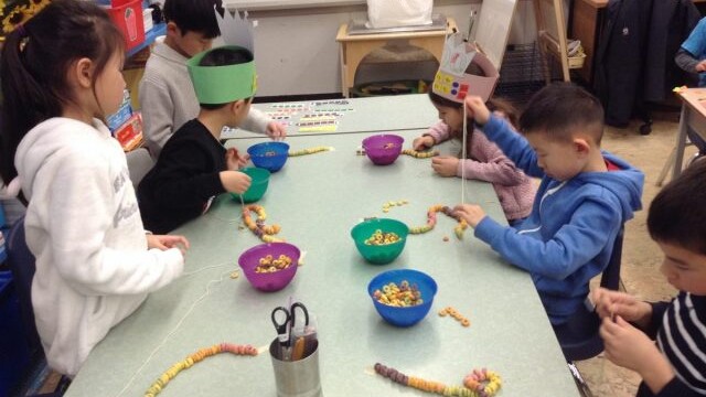 They made necklaces with ten groups of ten colours of Fruit Loops.